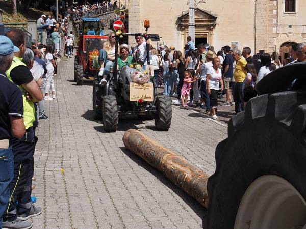 Dopo i muli e i cavalli, i bambini con i cestini di pagnottelle e i mezzi agricoli con travi di legno